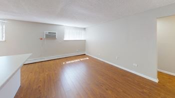 Hardwood style flooring in a large open bright white room  at 4805 E Kentucky in Denver, CO